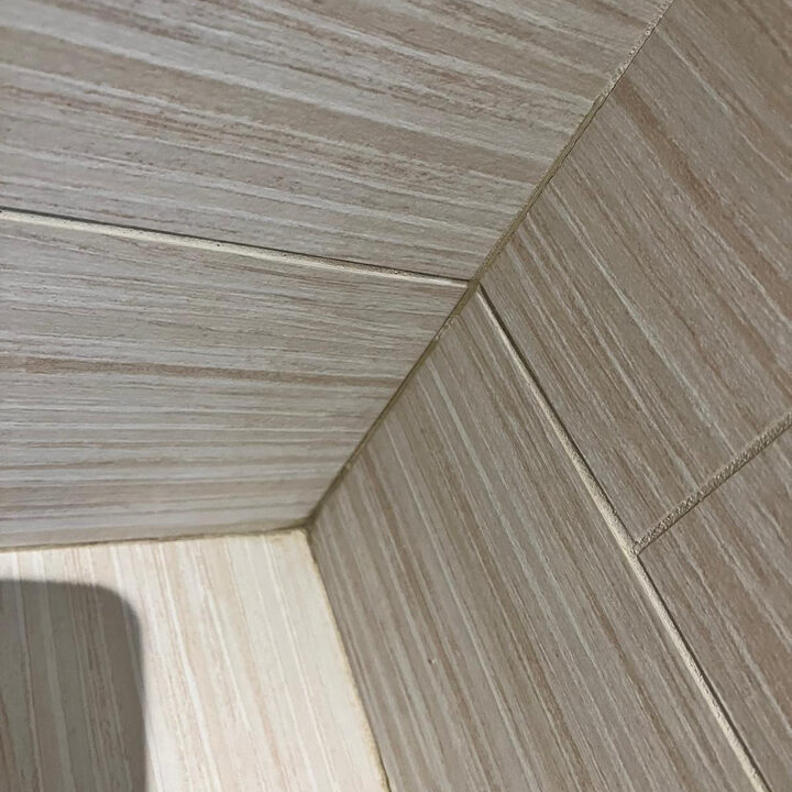 Image of warped bathtub tile causing a leak